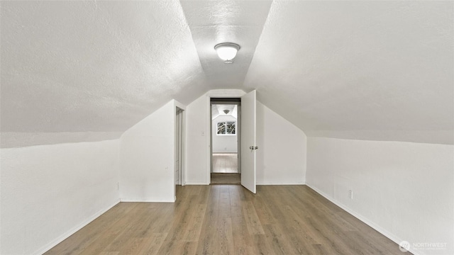 427 E Dayton Ave, Dayton, WA 99328 - bonus room featuring lofted ceiling, a textured ceiling, wood finished floors, and baseboards