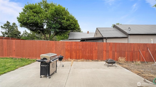 427 E Dayton Ave, Dayton, WA 99328 - fenced backyard featuring a grill, a patio, and a fire pit