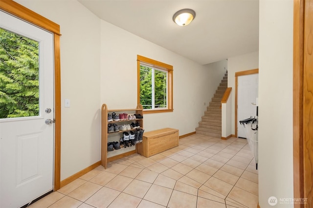6570 Cedar Glade Ln, Bainbridge Island, WA 98110 - foyer entrance featuring stairway, baseboards, and light tile patterned flooring