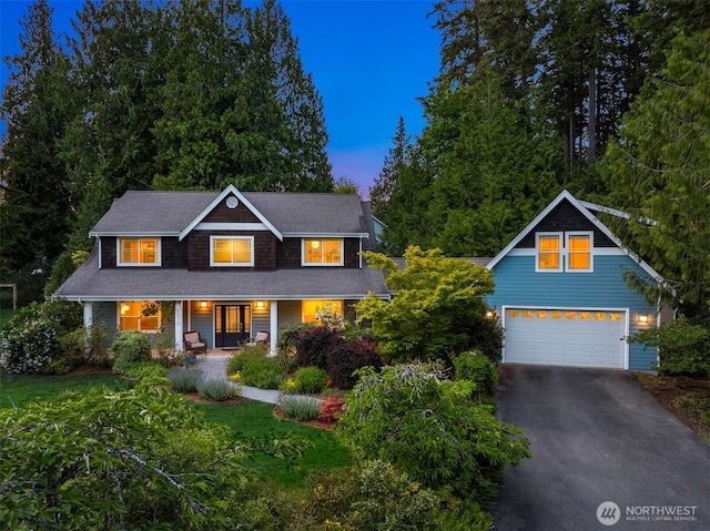 6570 Cedar Glade Ln, Bainbridge Island, WA 98110 - view of front of home with asphalt driveway, a garage, and covered porch