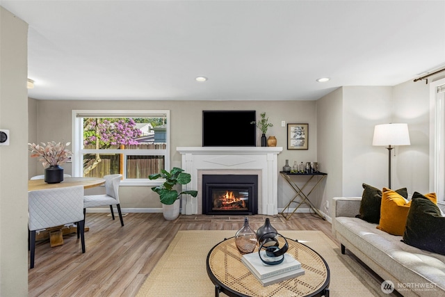 14011 Wallingford Ave N, Seattle, WA 98133 - living room featuring a glass covered fireplace, light wood-style flooring, recessed lighting, and baseboards