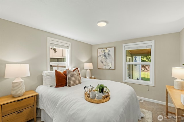 14011 Wallingford Ave N, Seattle, WA 98133 - bedroom with light carpet, multiple windows, and baseboards