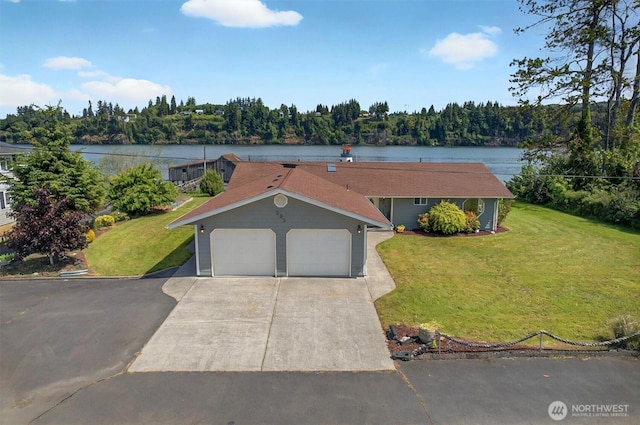 293 State Route 409, Cathlamet, WA 98612 - view of front of house with a front yard, driveway, a garage, a wooded view, and a water view
