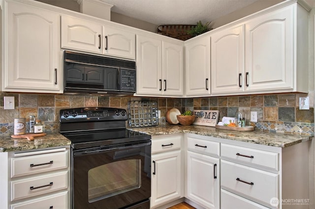 293 State Route 409, Cathlamet, WA 98612 - kitchen featuring black appliances, light stone counters, tasteful backsplash, and white cabinets