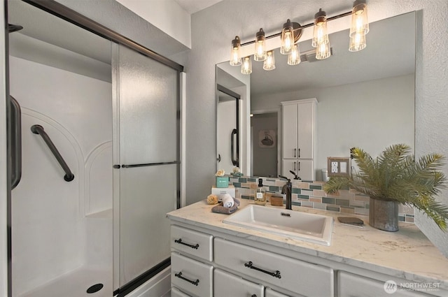 293 State Route 409, Cathlamet, WA 98612 - full bath featuring backsplash, vanity, a stall shower, and a textured wall