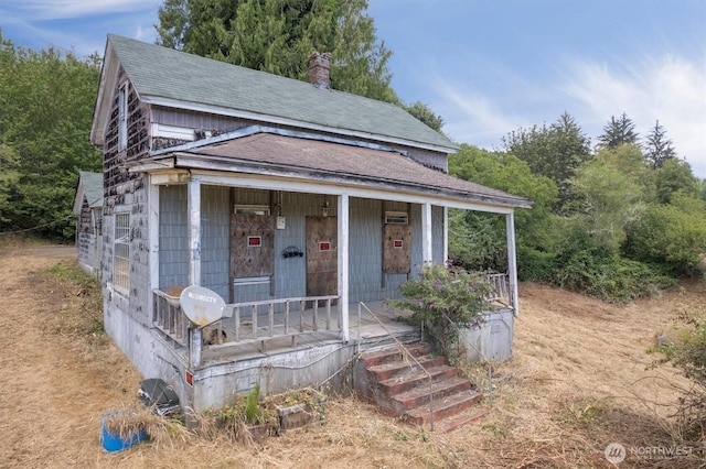 1908 W State Route 4 Unit 1, Skamokawa, WA 98647 - view of front facade with roof with shingles, covered porch, and a chimney