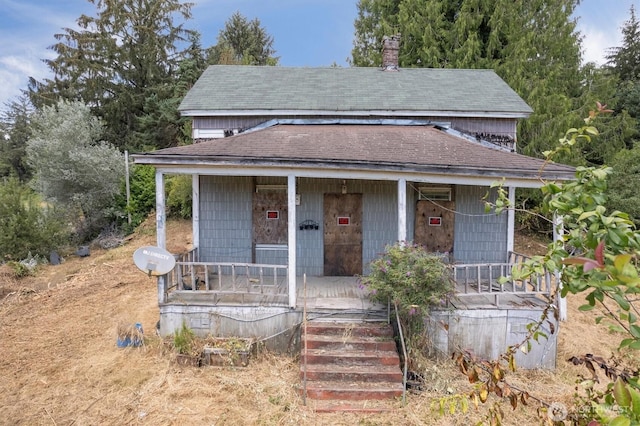 1908 W State Route 4 Unit 1, Skamokawa, WA 98647 - view of front of house with a porch, a shingled roof, a chimney, and stairs