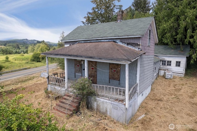 1908 W State Route 4 Unit 1, Skamokawa, WA 98647 - view of front of home with roof with shingles, a porch, a chimney, and crawl space