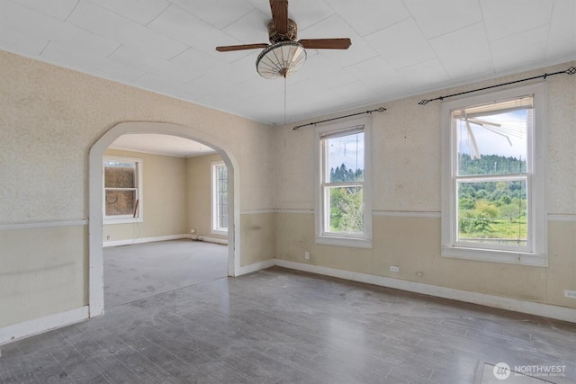 1908 W State Route 4 Unit 1, Skamokawa, WA 98647 - unfurnished room with arched walkways, a ceiling fan, wood finished floors, and baseboards