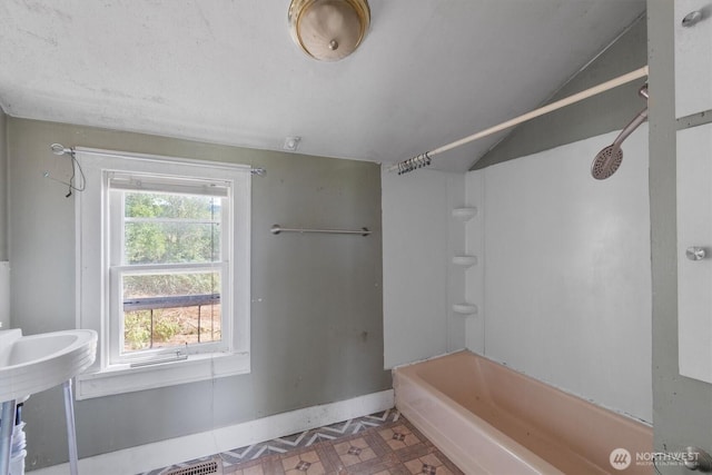 1908 W State Route 4 Unit 1, Skamokawa, WA 98647 - bathroom featuring baseboards, shower / bathtub combination, and inlaid floor details