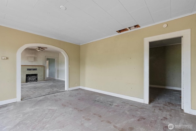 1908 W State Route 4 Unit 1, Skamokawa, WA 98647 - unfurnished room with ornamental molding, arched walkways, a fireplace, and baseboards