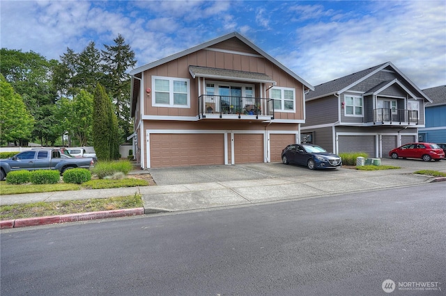6018 Illinois Ln SE Unit B, Lacey, WA 98513 - view of front of property featuring an attached garage, board and batten siding, concrete driveway, and a balcony