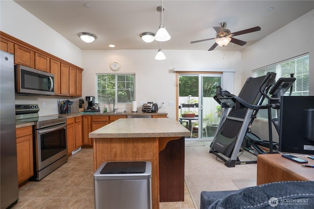 6018 Illinois Ln SE Unit B, Lacey, WA 98513 - kitchen featuring stainless steel appliances, a center island, a sink, light countertops, and brown cabinets