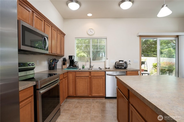 6018 Illinois Ln SE Unit B, Lacey, WA 98513 - kitchen with appliances with stainless steel finishes, a sink, brown cabinets, and plenty of natural light