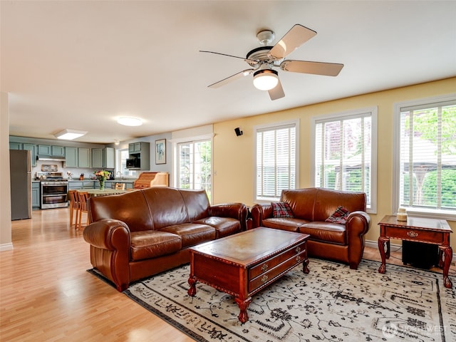 1717 24th Ave Court SE, Puyallup, WA 98374 - living area with light wood finished floors, ceiling fan, and baseboards