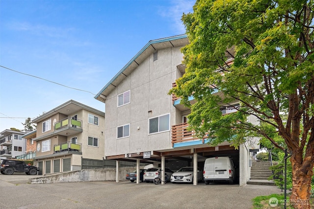 6710 24th Ave NW, Seattle, WA 98117 - view of building exterior with stairs and covered parking