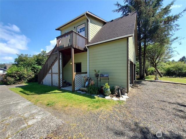 248 Ensign Ave NW, Ocean Shores, WA 98569 - back of house with roof with shingles, stairs, and a yard