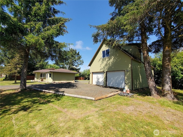 248 Ensign Ave NW, Ocean Shores, WA 98569 - view of side of property featuring a yard, an attached garage, and driveway