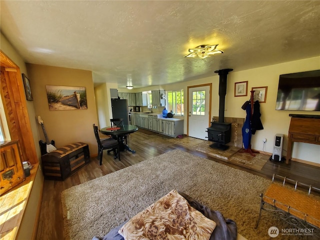 248 Ensign Ave NW, Ocean Shores, WA 98569 - living area with wood finished floors and a wood stove
