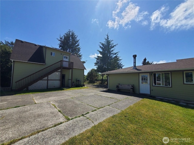 248 Ensign Ave NW, Ocean Shores, WA 98569 - rear view of property featuring stairway and a lawn