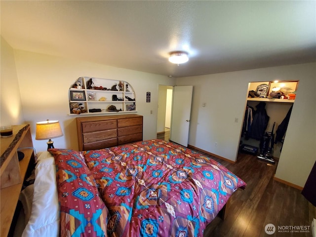 248 Ensign Ave NW, Ocean Shores, WA 98569 - bedroom with wood finished floors, baseboards, and a spacious closet