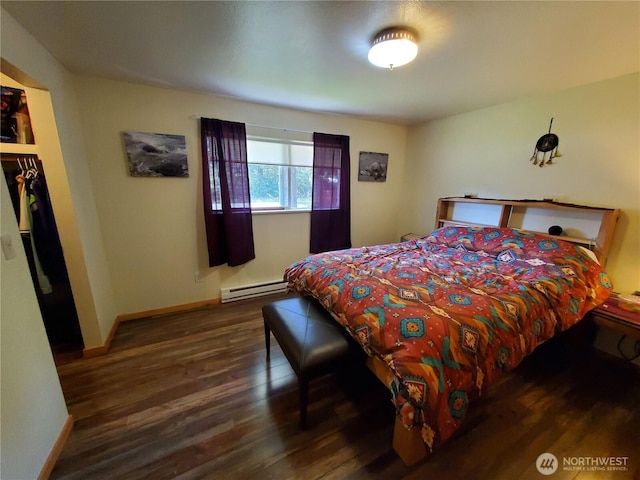 248 Ensign Ave NW, Ocean Shores, WA 98569 - bedroom with wood finished floors, a baseboard heating unit, baseboards, and a closet