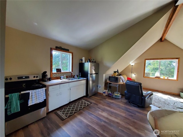 248 Ensign Ave NW, Ocean Shores, WA 98569 - kitchen with appliances with stainless steel finishes, white cabinets, healthy amount of natural light, and dark wood-style floors