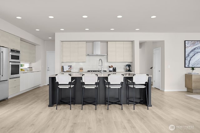 4171 Wandering Way, Port Orchard, WA 98367 - kitchen with modern cabinets, wall chimney exhaust hood, light wood-style flooring, light countertops, and recessed lighting
