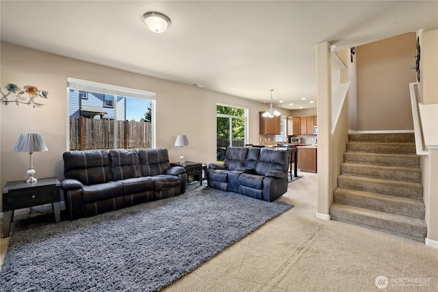 9831 198th St E, Graham, WA 98338 - living room with light carpet, stairway, a chandelier, and baseboards