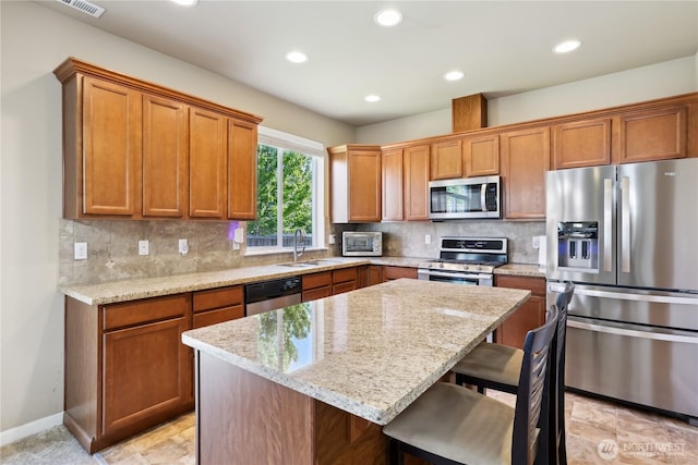 9831 198th St E, Graham, WA 98338 - kitchen featuring stainless steel appliances, a sink, a kitchen breakfast bar, a center island, and recessed lighting