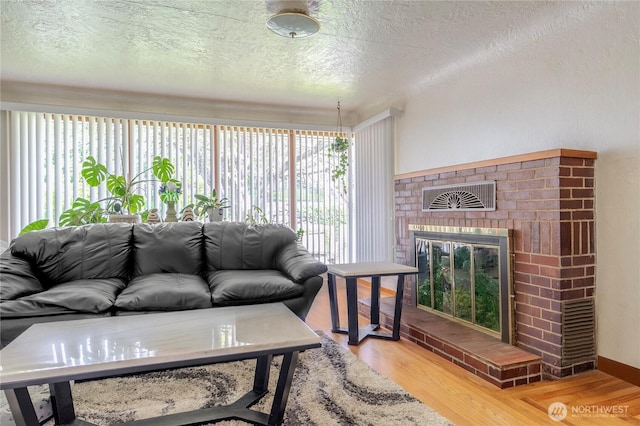 9829 60th Ave S, Seattle, WA 98118 - living area with a textured ceiling, wood finished floors, and a fireplace