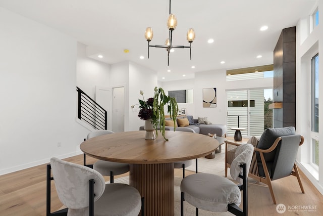 8337 14th Ave NW Unit A, Seattle, WA 98117 - dining area with light wood finished floors, a chandelier, recessed lighting, and baseboards