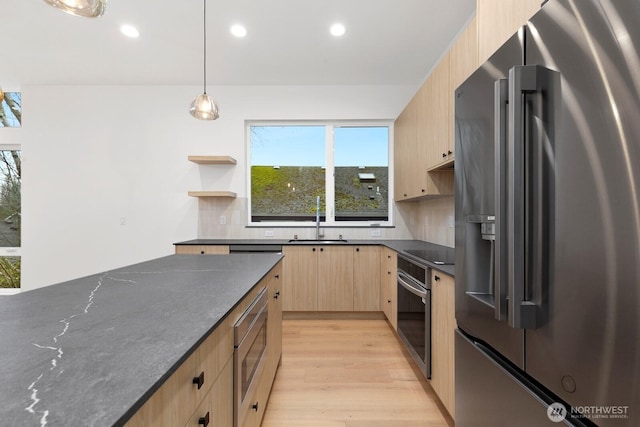 8337 14th Ave NW Unit A, Seattle, WA 98117 - kitchen featuring stainless steel appliances, light brown cabinetry, a sink, light wood finished floors, and backsplash