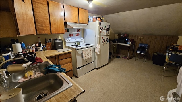 107 Carrolls Ave, Carrolls, WA 98609 - kitchen with white appliances, under cabinet range hood, brown cabinetry, light floors, and vaulted ceiling
