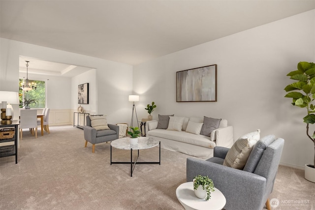 23600 Dunbar Pl NW, Poulsbo, WA 98370 - living area with light carpet, a chandelier, and a wainscoted wall
