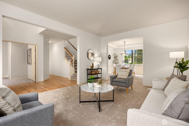23600 Dunbar Pl NW, Poulsbo, WA 98370 - living area with stairway, light wood-type flooring, and a chandelier