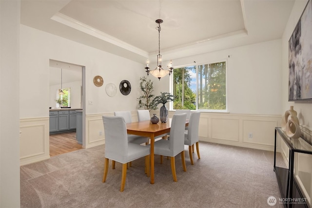 23600 Dunbar Pl NW, Poulsbo, WA 98370 - dining area featuring carpet floors, a tray ceiling, plenty of natural light, a decorative wall, and a wainscoted wall