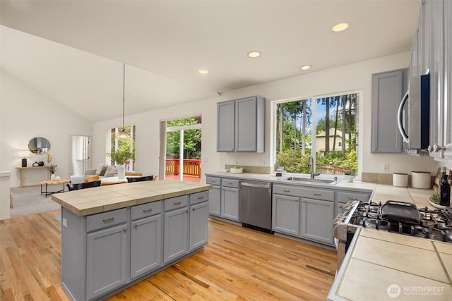 23600 Dunbar Pl NW, Poulsbo, WA 98370 - kitchen with gray cabinets, appliances with stainless steel finishes, light wood finished floors, a center island, and recessed lighting