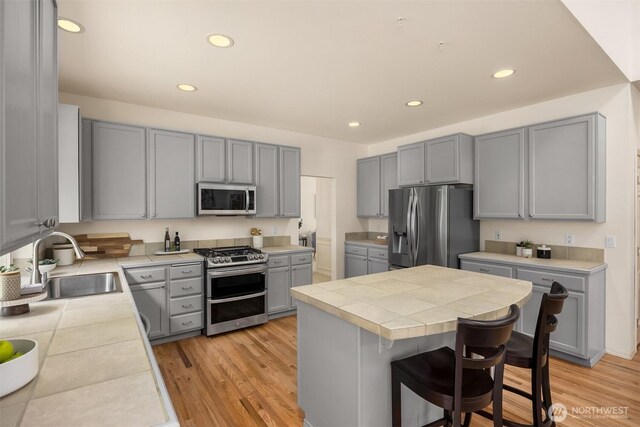 23600 Dunbar Pl NW, Poulsbo, WA 98370 - kitchen with stainless steel appliances, gray cabinets, tile countertops, and recessed lighting