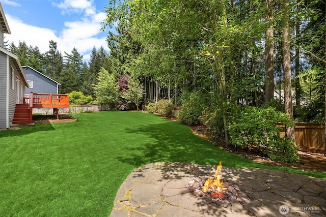 23600 Dunbar Pl NW, Poulsbo, WA 98370 - fenced backyard with an outdoor fire pit, a deck, and a patio area