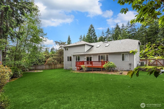 23600 Dunbar Pl NW, Poulsbo, WA 98370 - back of house with a fenced backyard, a wooden deck, and roof with shingles