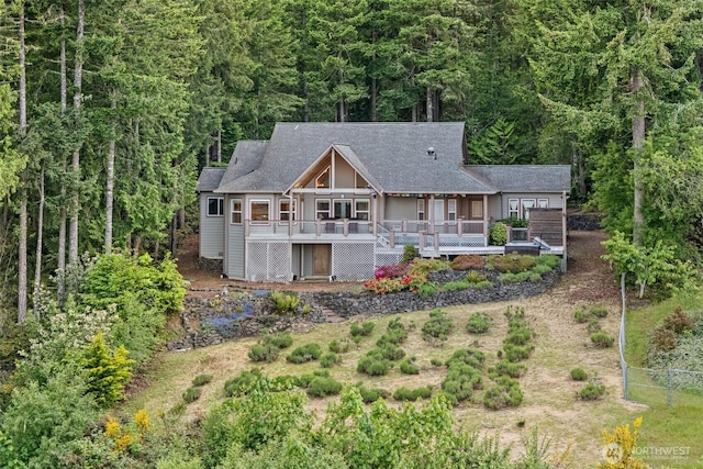 14647 NW Honeyhill Loop, Seabeck, WA 98380 - rear view of house with a deck and a wooded view
