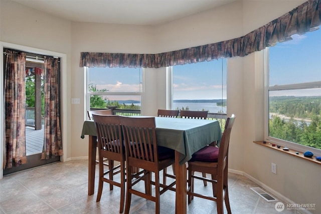 14647 NW Honeyhill Loop, Seabeck, WA 98380 - dining room featuring baseboards and a water view