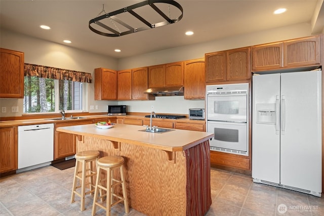 14647 NW Honeyhill Loop, Seabeck, WA 98380 - kitchen featuring white appliances, a sink, under cabinet range hood, recessed lighting, and light countertops