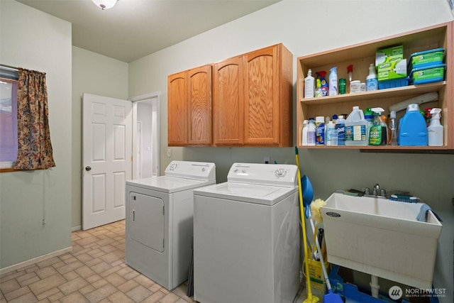 14647 NW Honeyhill Loop, Seabeck, WA 98380 - laundry area with washing machine and dryer, cabinet space, brick patterned floors, and baseboards