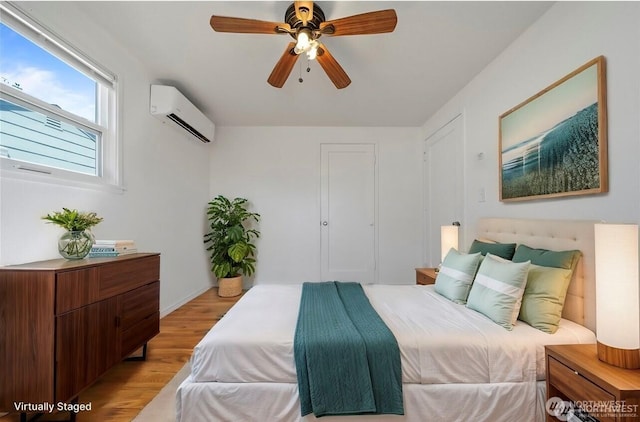177 E St SE, Ephrata, WA 98823 - bedroom with a wall mounted air conditioner, light wood finished floors, and ceiling fan