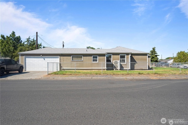 177 E St SE, Ephrata, WA 98823 - view of front of house featuring a garage, a fenced front yard, and driveway