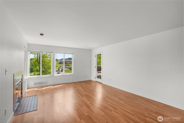 10329 Meridian Ave N Unit A201, Seattle, WA 98133 - unfurnished living room featuring light wood finished floors and baseboards