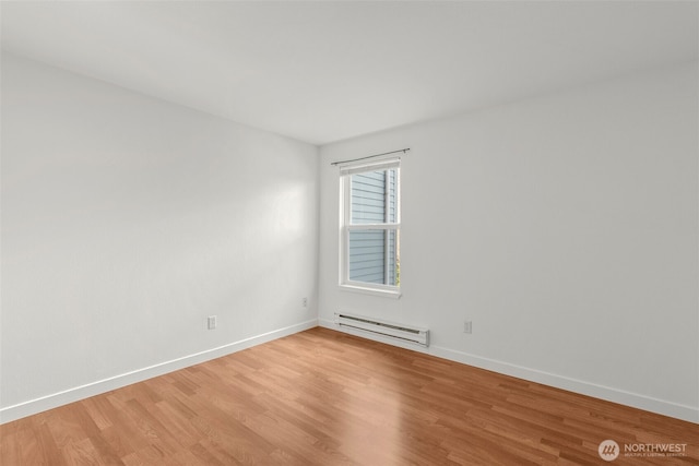 10329 Meridian Ave N Unit A201, Seattle, WA 98133 - empty room with a baseboard heating unit, light wood-style floors, and baseboards
