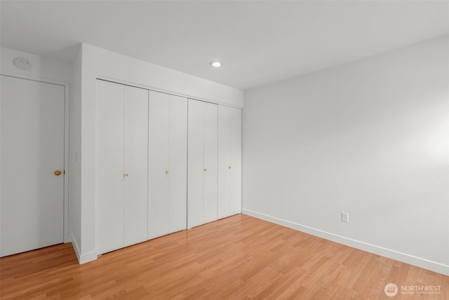 10329 Meridian Ave N Unit A201, Seattle, WA 98133 - unfurnished bedroom featuring light wood-style floors, a closet, recessed lighting, and baseboards